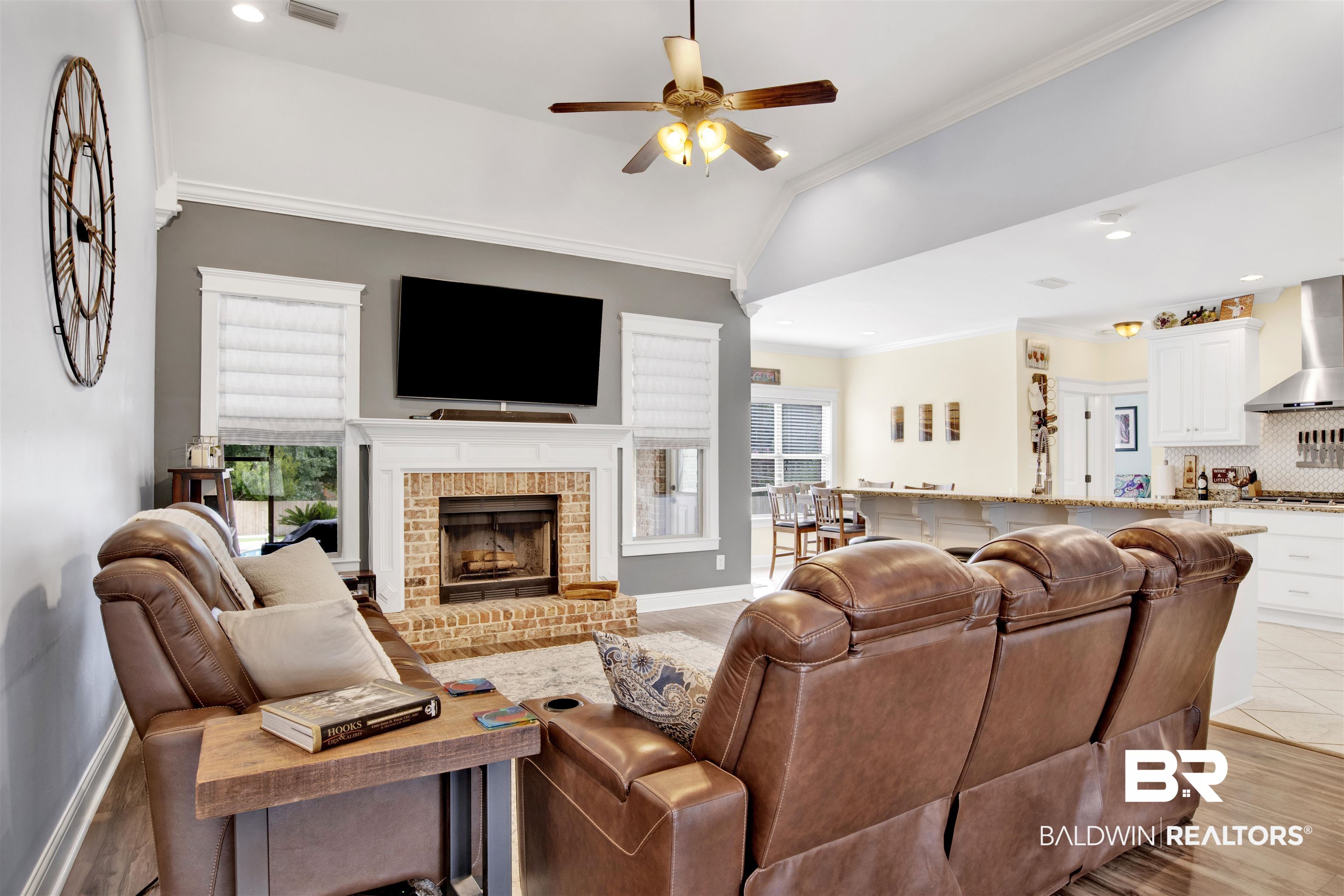 12418 Cambron Trail Daphne, AL 36527 - Photo 17 of 44 Living room featuring crown molding, vaulted ceiling, a brick fireplace, and ceiling fan