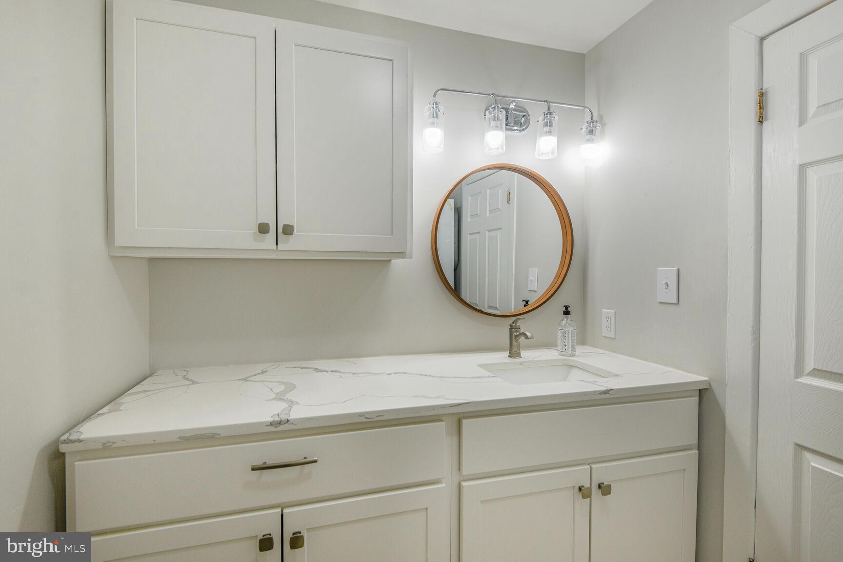 38 Pleasant Street Annapolis, MD 21401 - Photo 18 of 22 a bathroom with a sink and a mirror