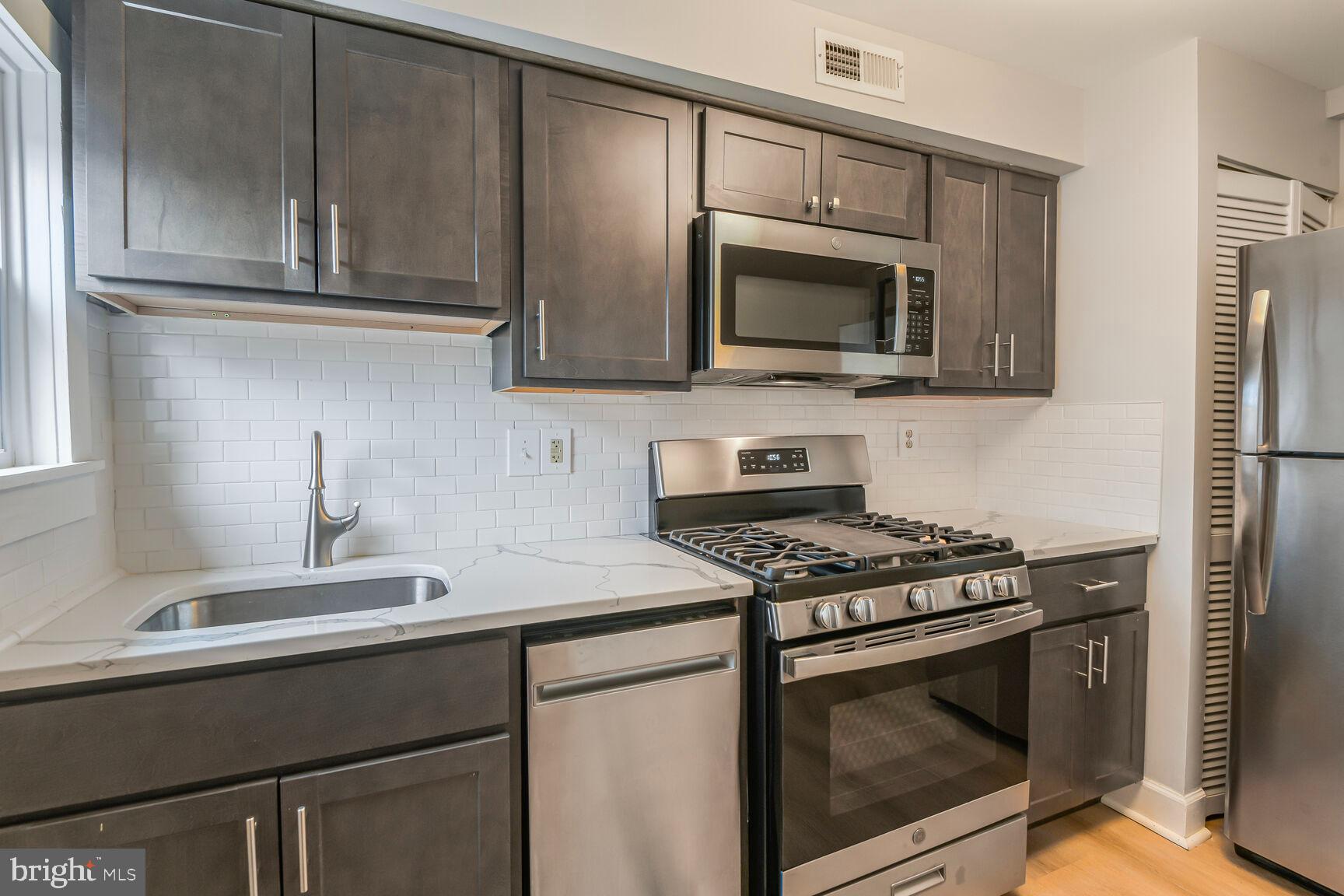 38 Pleasant Street Annapolis, MD 21401 - Photo 3 of 22 a kitchen with stainless steel appliances a stove microwave and sink