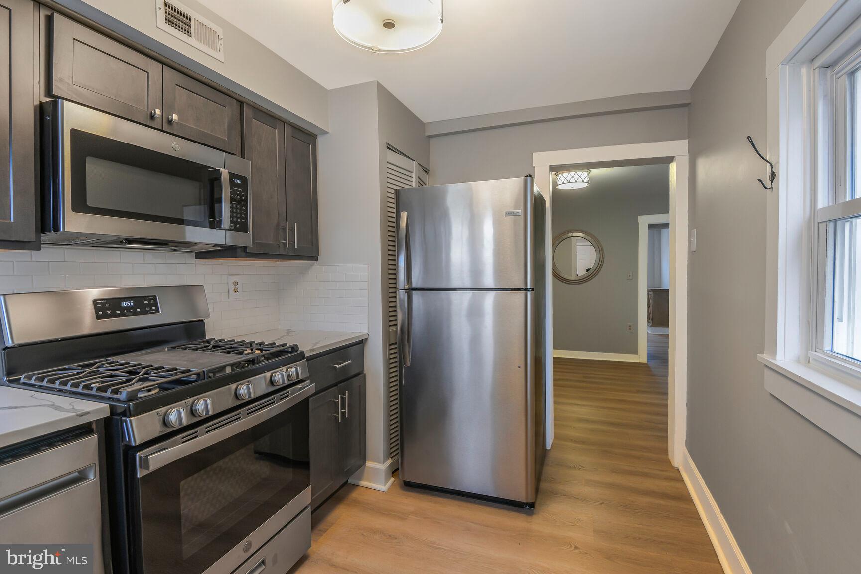38 Pleasant Street Annapolis, MD 21401 - Photo 4 of 22 a kitchen with stainless steel appliances granite countertop a stove microwave and refrigerator