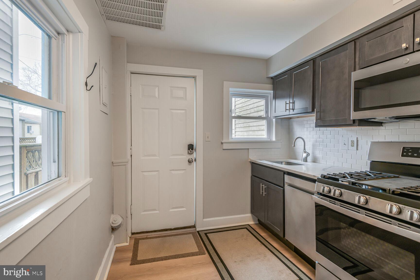 38 Pleasant Street Annapolis, MD 21401 - Photo 5 of 22 a kitchen with stainless steel appliances a stove microwave and sink