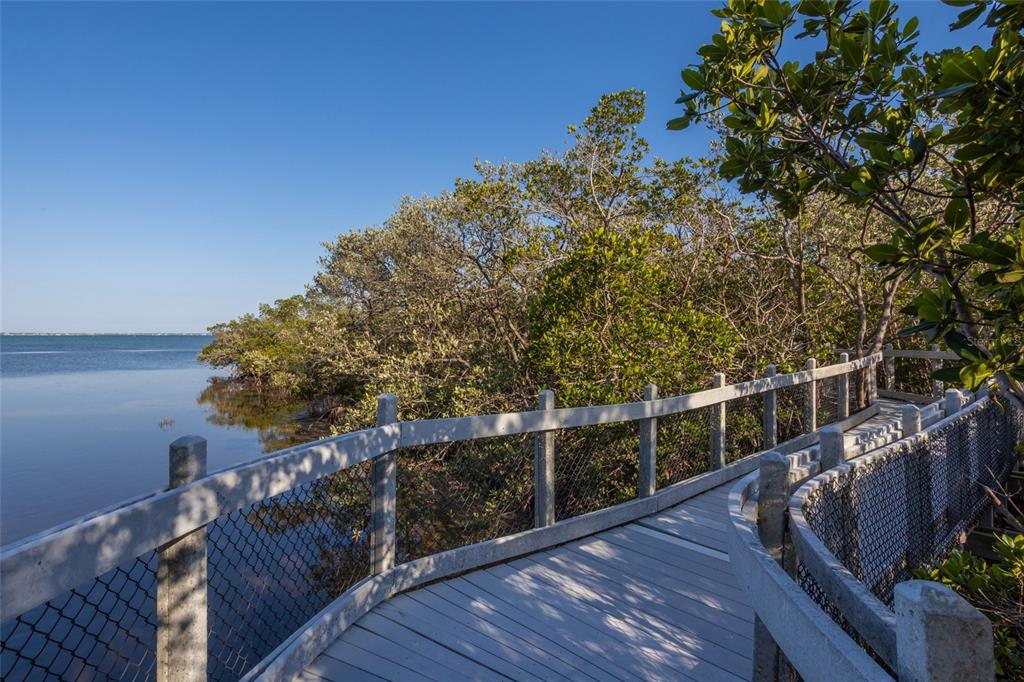 560 Gulf Bay Road Longboat Key, FL 34228 - Photo 21 of 38 a view of balcony with wooden floor and fence