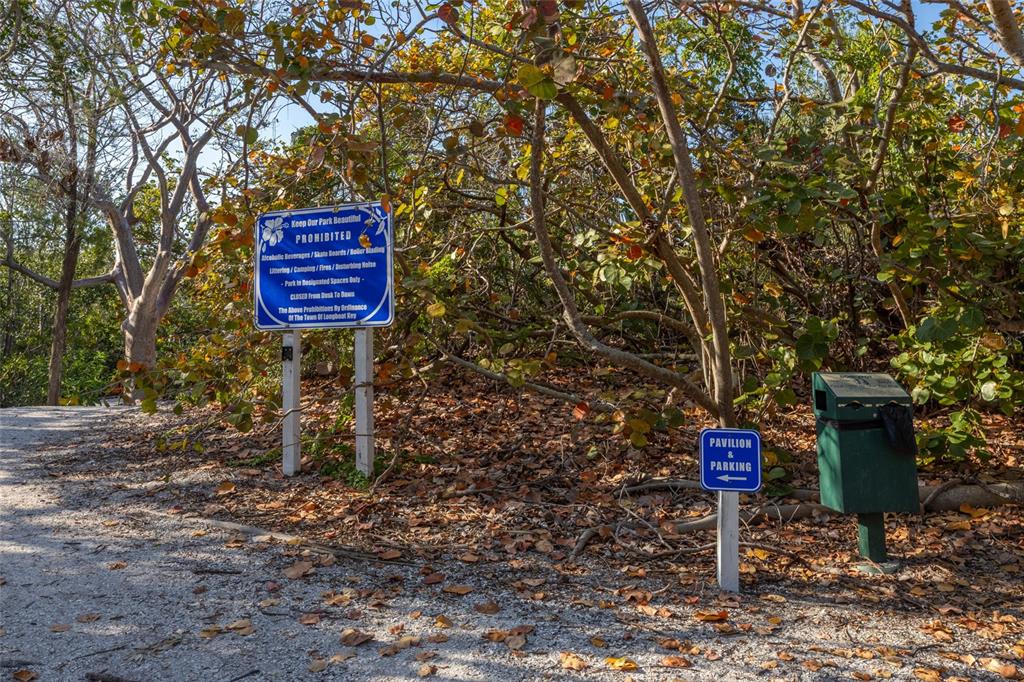 560 Gulf Bay Road Longboat Key, FL 34228 - Photo 36 of 38 a sign board with a tree in the background