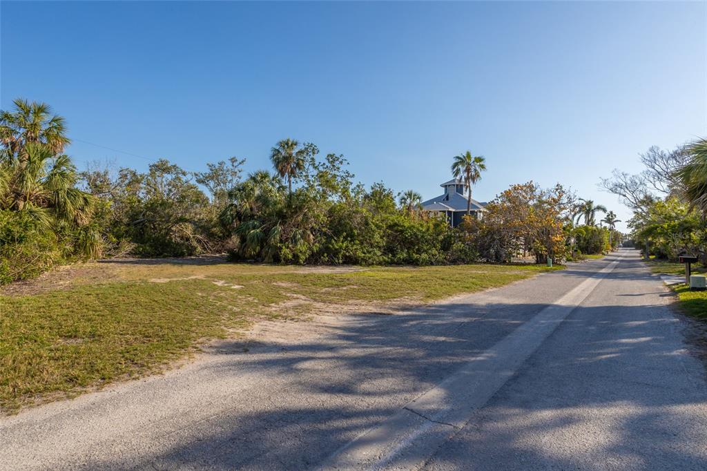 560 Gulf Bay Road Longboat Key, FL 34228 - Photo 5 of 38 a view of a swimming pool with an outdoor space and seating area