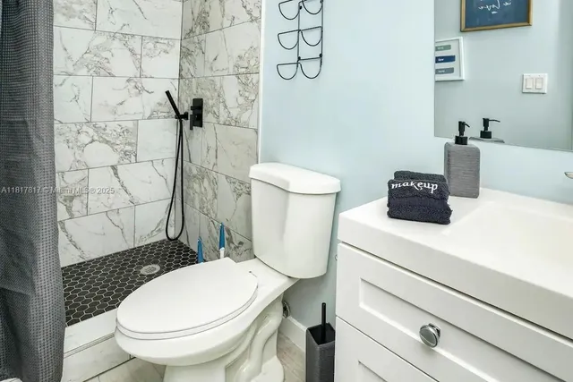 a bathroom with a toilet and a shower