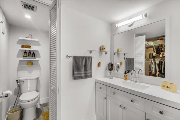 a bathroom with a toilet sink and shower