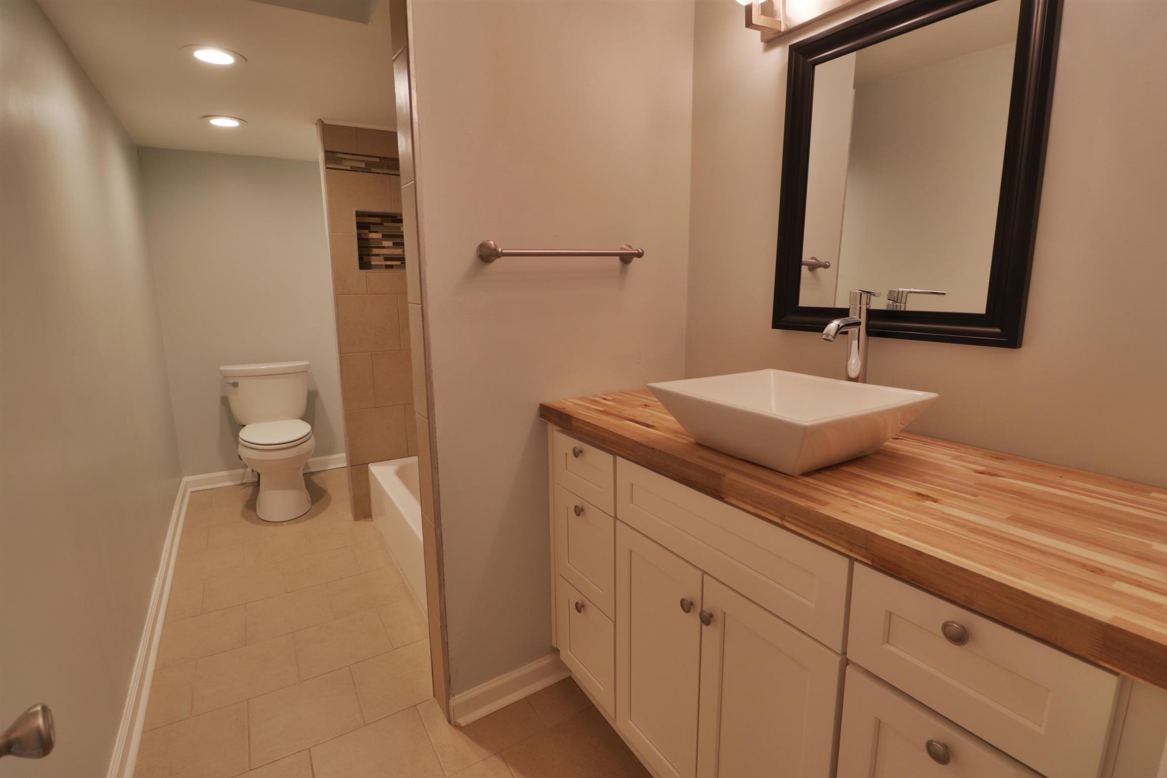 5635 Murfreesboro Road Lebanon, TN 37090 - Photo 14 of 29 a bathroom with a toilet a sink and mirror