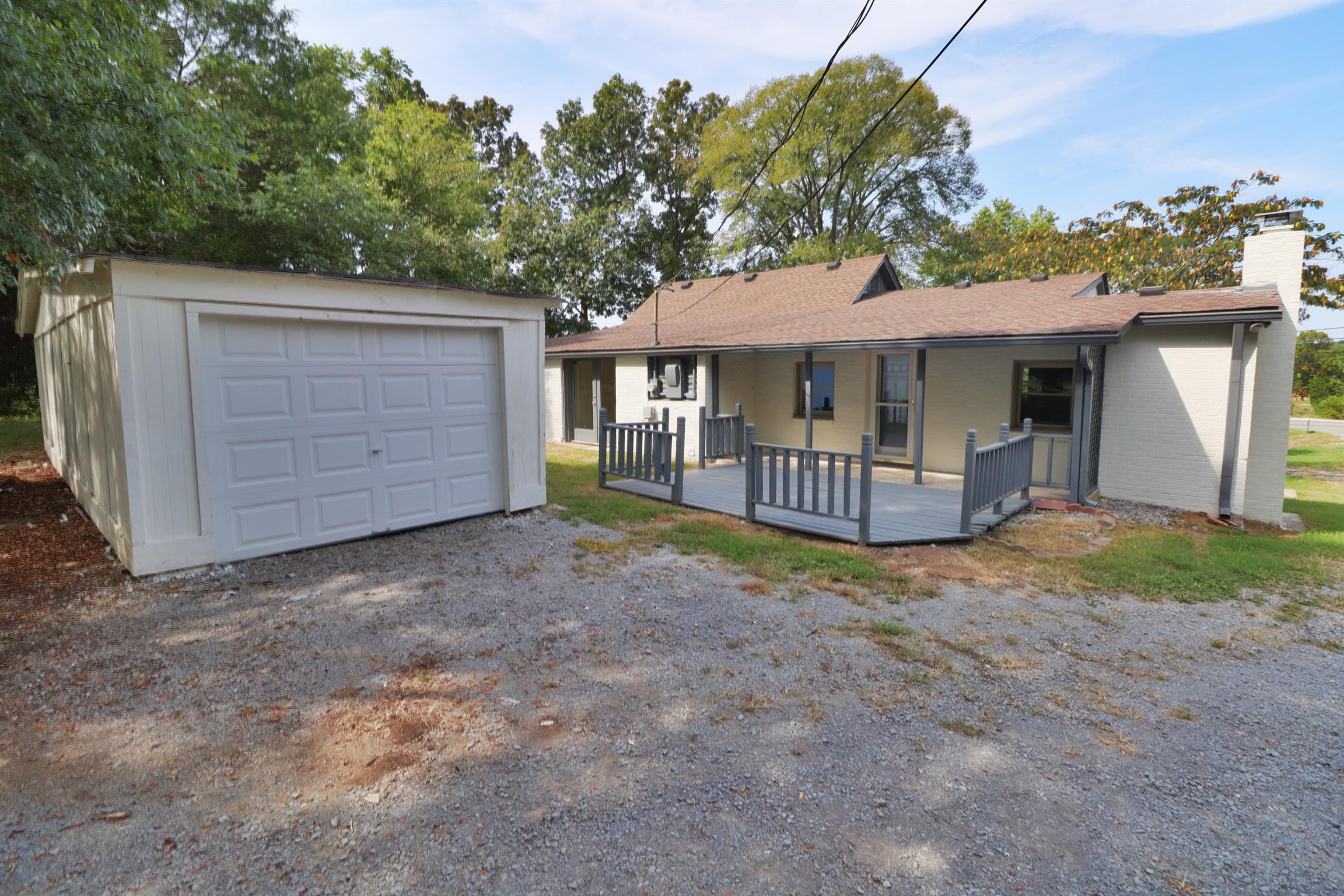 5635 Murfreesboro Road Lebanon, TN 37090 - Photo 8 of 29 a view of a house with a yard and garage