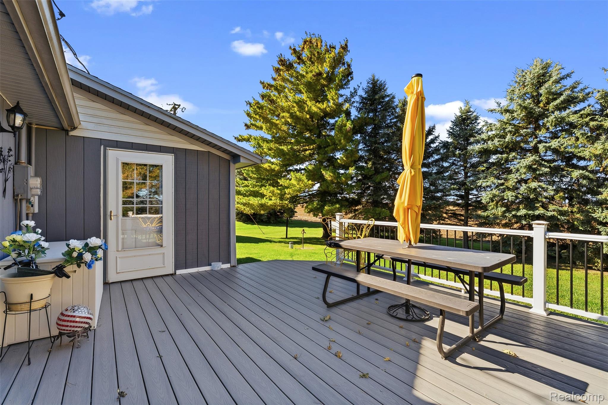 2227 North Graf Road Caro, MI 48723 - Photo 47 of 51 Spacious outdoor deck with composite decking, white railing, and a glass-paneled door