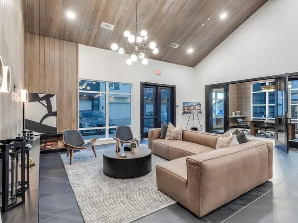 a living room with furniture and a chandelier