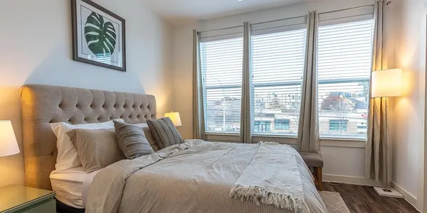 a bed sitting in a bedroom next to a window
