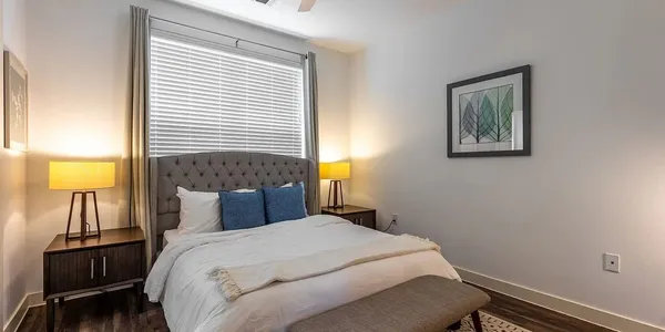 a bedroom with a bed and a lamp