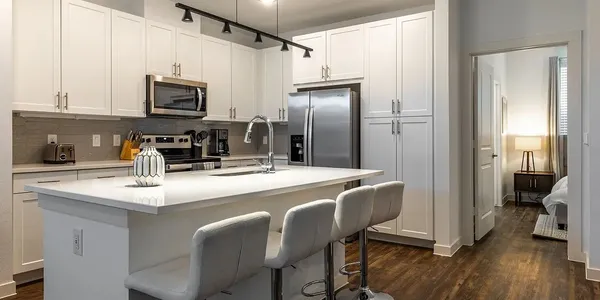 a kitchen with stainless steel appliances a sink and a refrigerator
