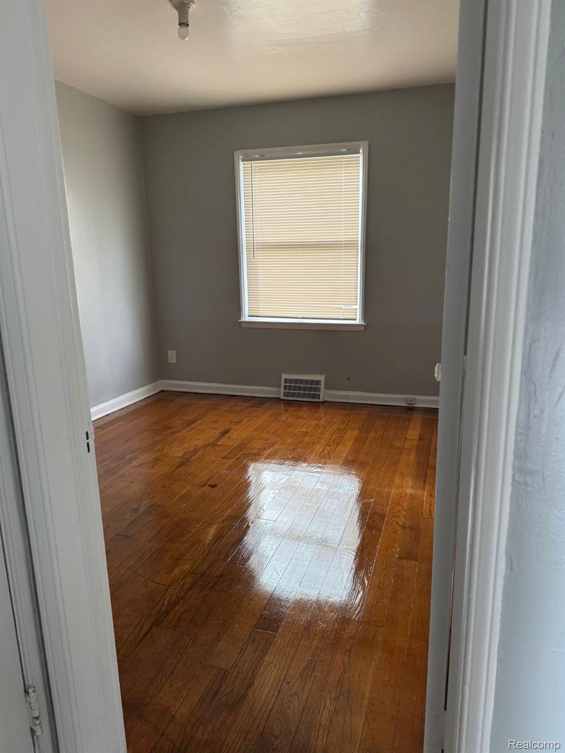 19706 Moross Road Detroit, MI 48224 - Photo 11 of 13 Hardwood flooring complemented by neutral wall tones
