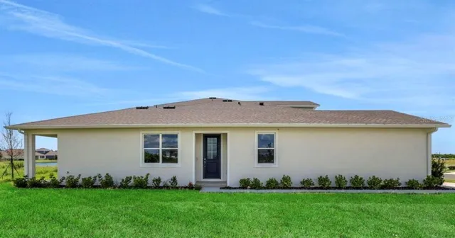 a view of a house with a backyard