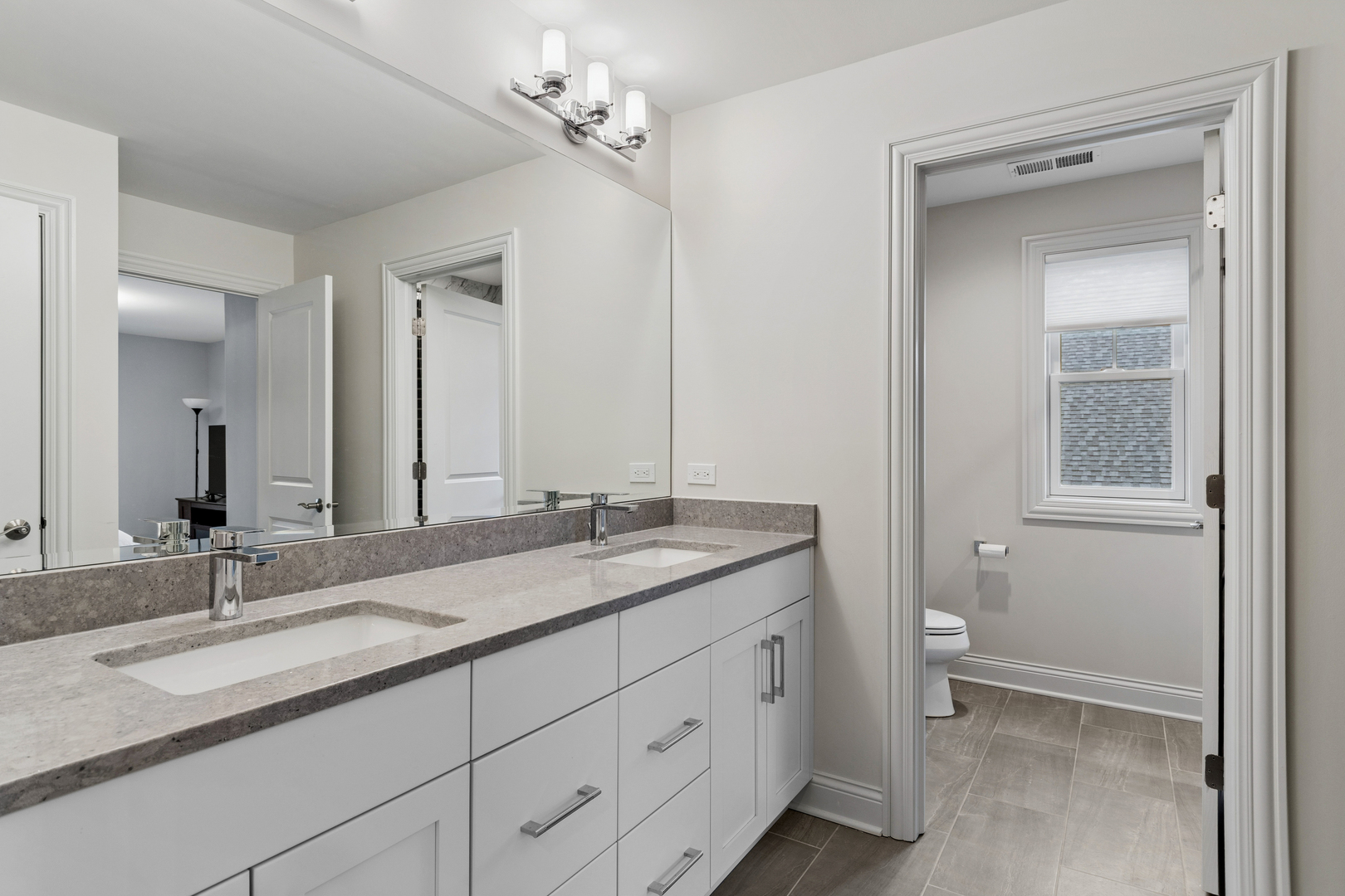 1759 Provenance Way Northbrook, IL 60062 - Photo 27 of 38 a bathroom with a granite countertop sink a toilet and a mirror