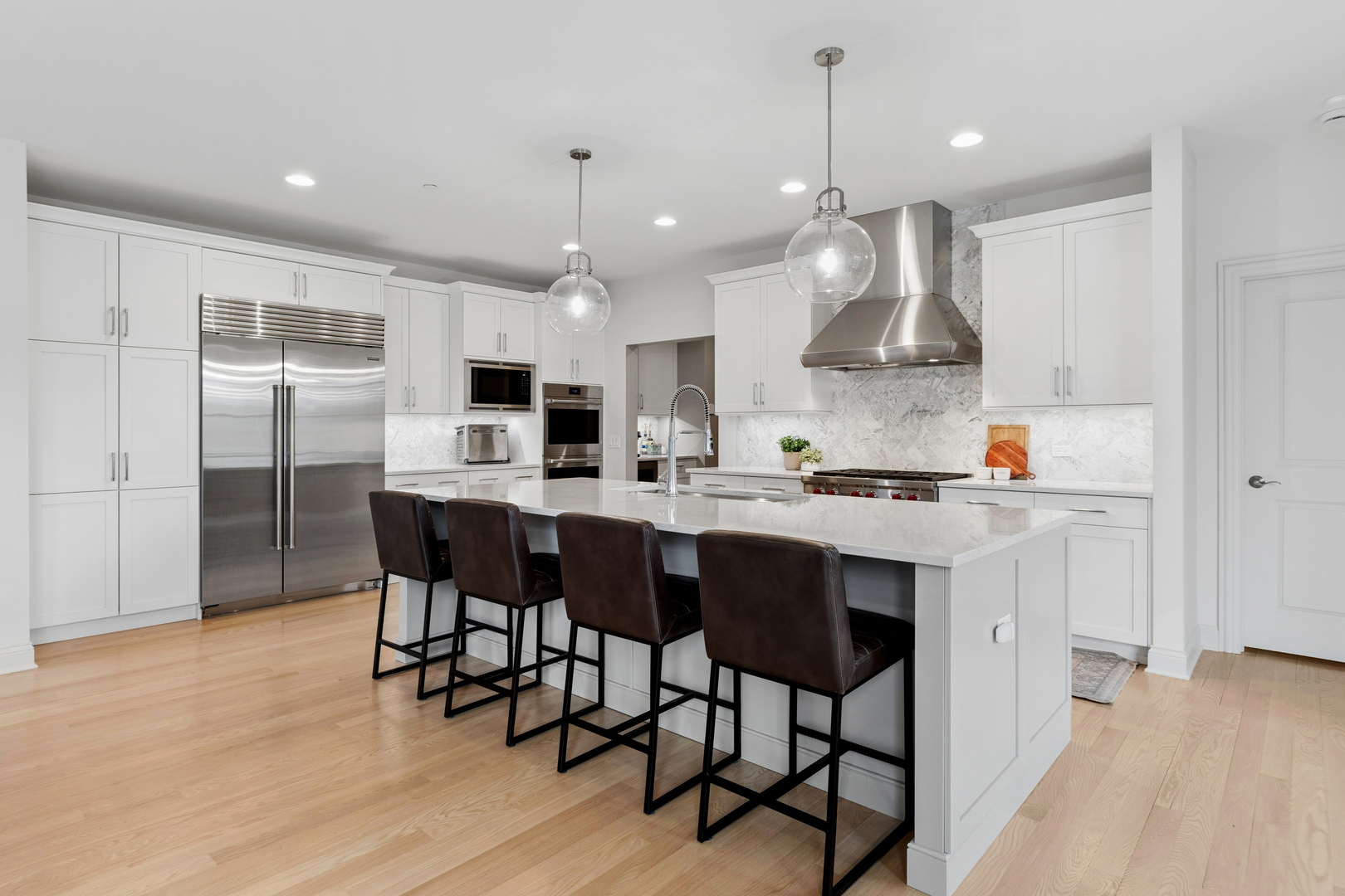 1759 Provenance Way Northbrook, IL 60062 - Photo 10 of 38 a kitchen with stainless steel appliances kitchen island granite countertop a sink a stove a refrigerator and white cabinets with wooden floor