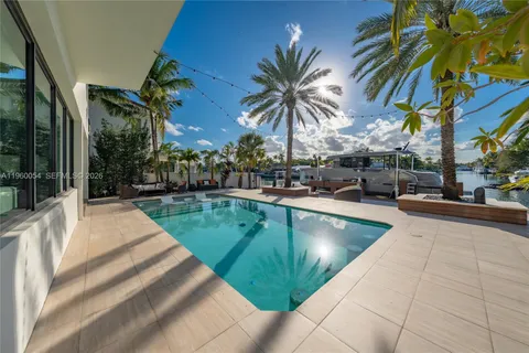 a view of a backyard with swimming pool