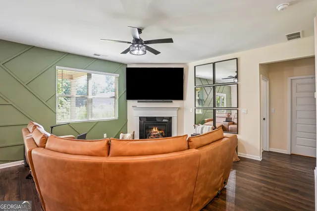 a living room with furniture a fireplace and a flat screen tv