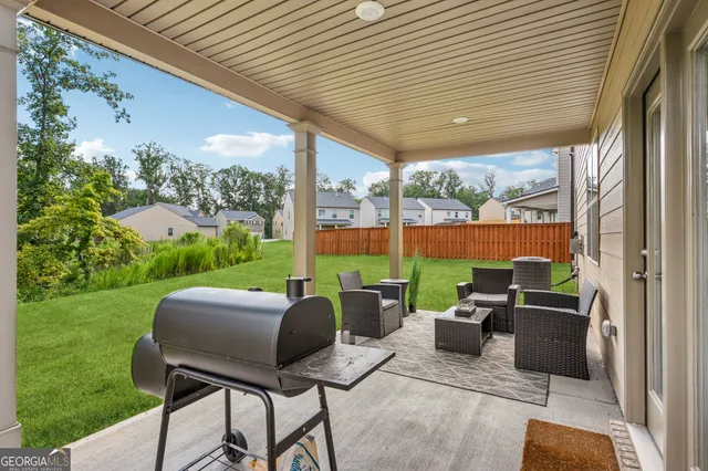 a view of swimming pool with a yard and sitting area