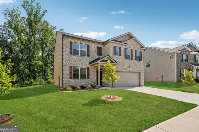 a front view of house with yard and green space