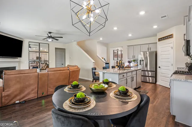 a open dining room with furniture and a kitchen view