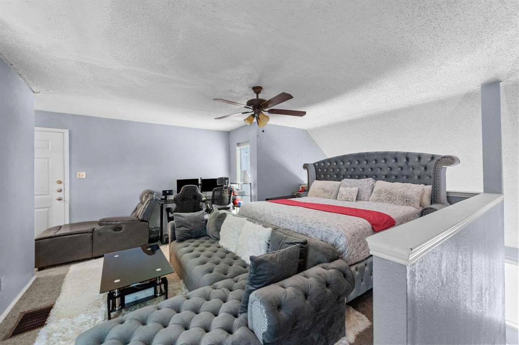 9815 Walnut Street, Unit 204 Dallas, TX 75243 - Photo 13 of 29 a bedroom with furniture and a chandelier