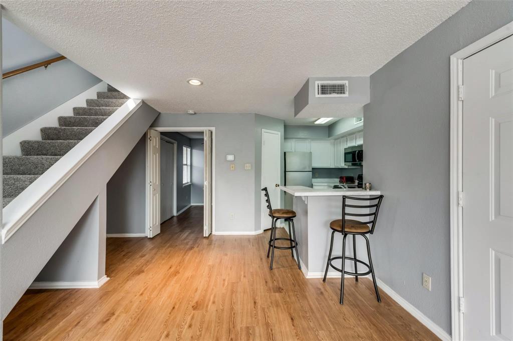 9815 Walnut Street, Unit 204 Dallas, TX 75243 - Photo 22 of 29 a view of a dining room with furniture and wooden floor