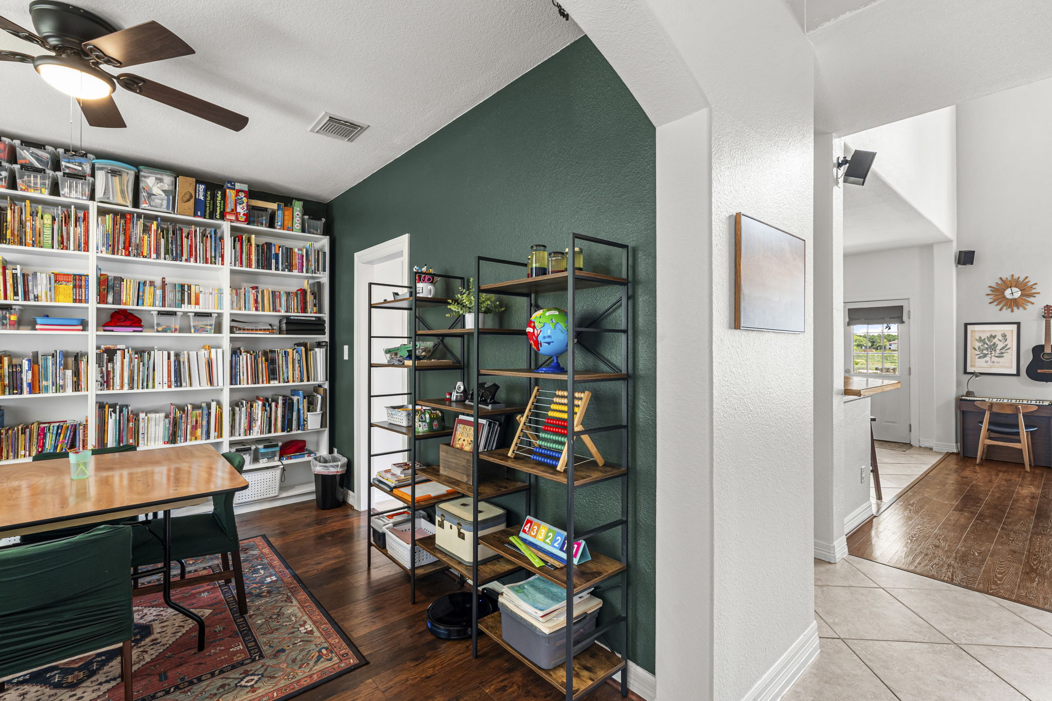 454 Fall Circle Kyle, TX 78640 - Photo 4 of 39 A well-appointed office space boasts extensive built-in shelving, perfect for a home library or study.