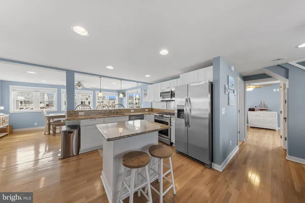 a view of a dining room kitchen with furniture and wooden floor