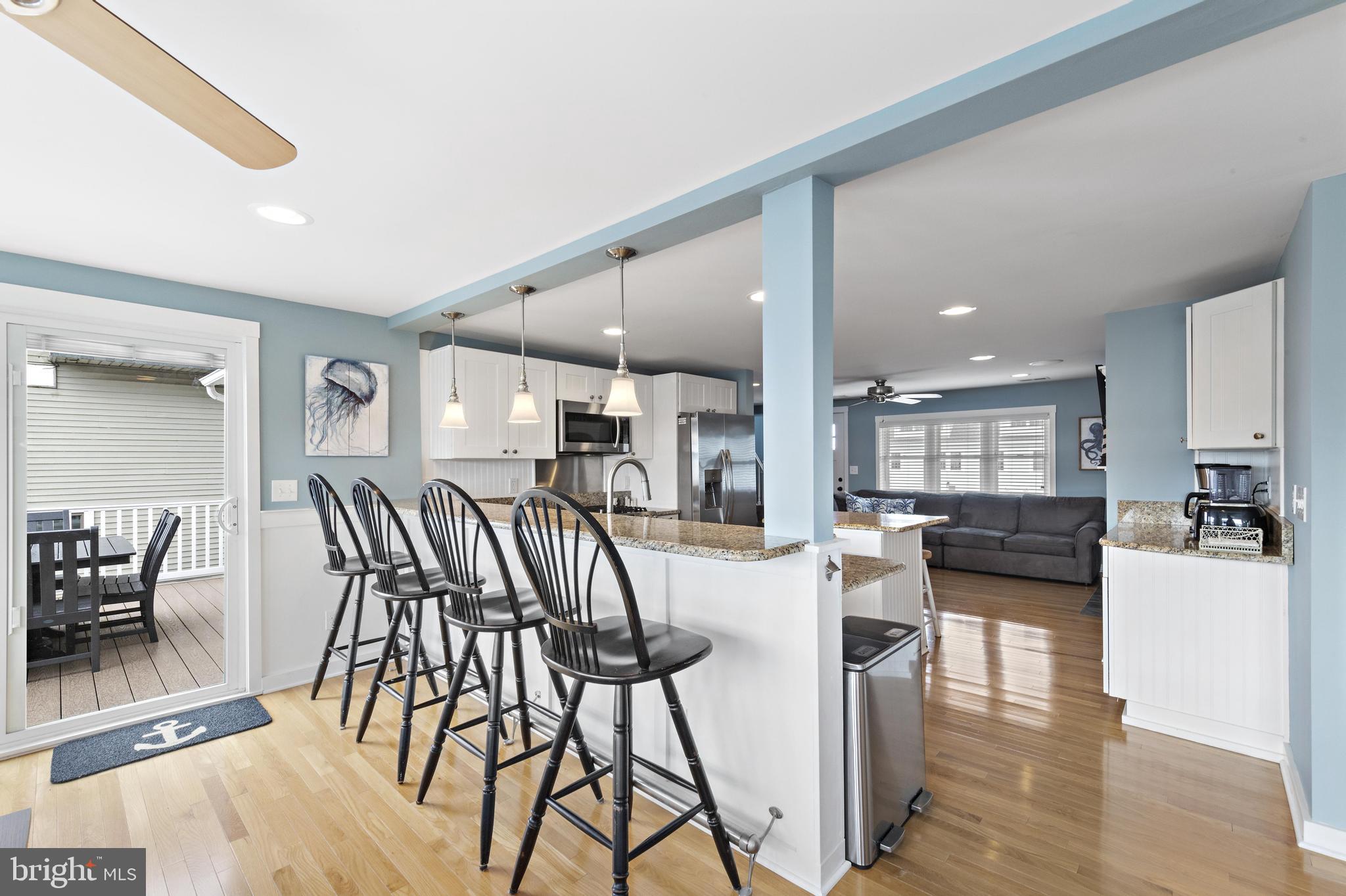 304 Morris Boulevard Manahawkin, NJ 08050 - Photo 14 of 55 a view of a dining room kitchen with furniture and wooden floor