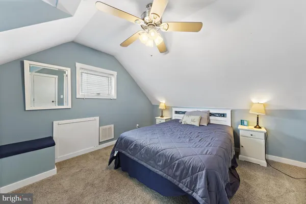 a bedroom with two beds and a dresser