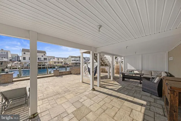 a view of a terrace with lawn chairs