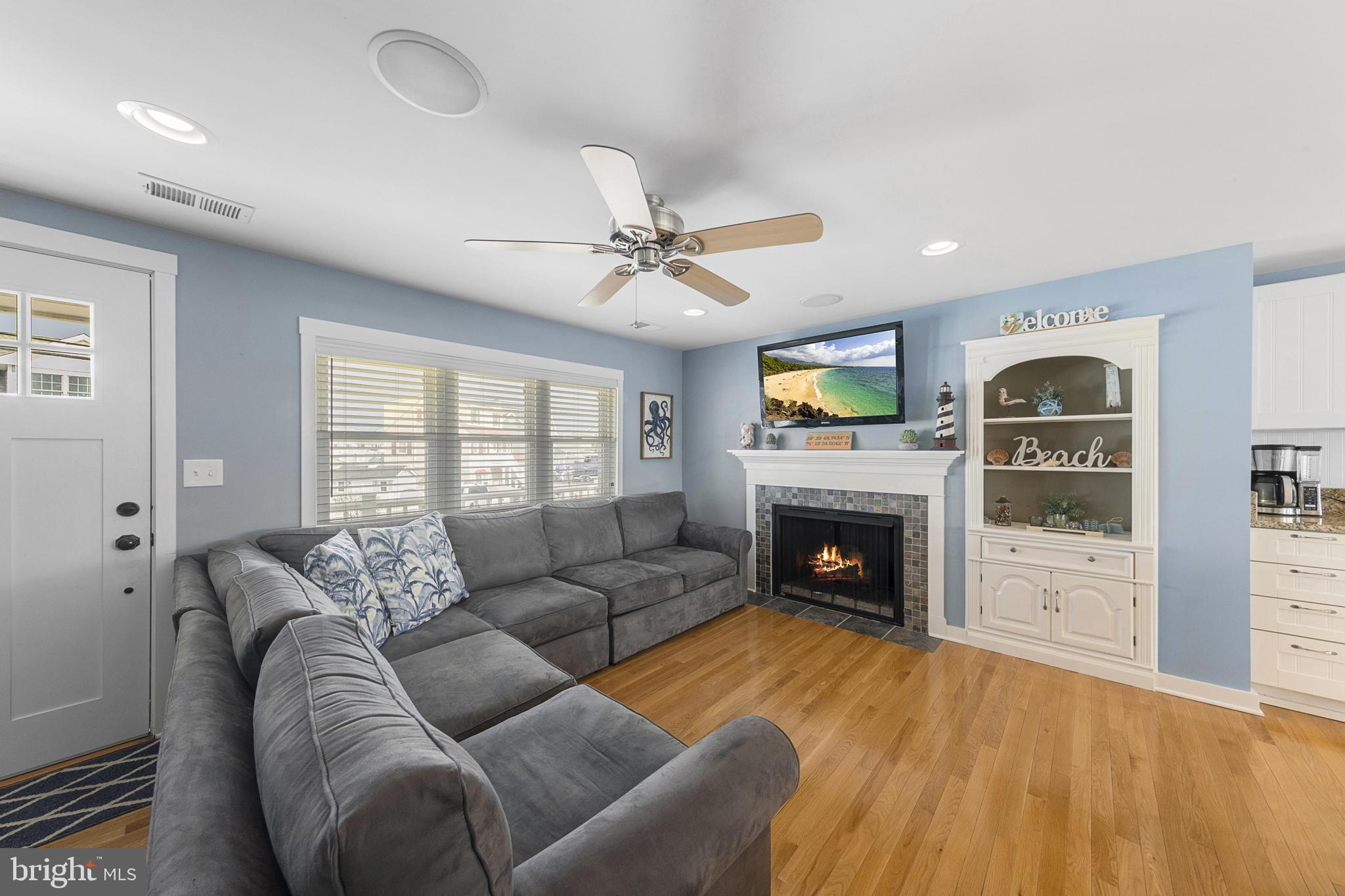 304 Morris Boulevard Manahawkin, NJ 08050 - Photo 8 of 55 a living room with furniture flat screen tv and a fireplace