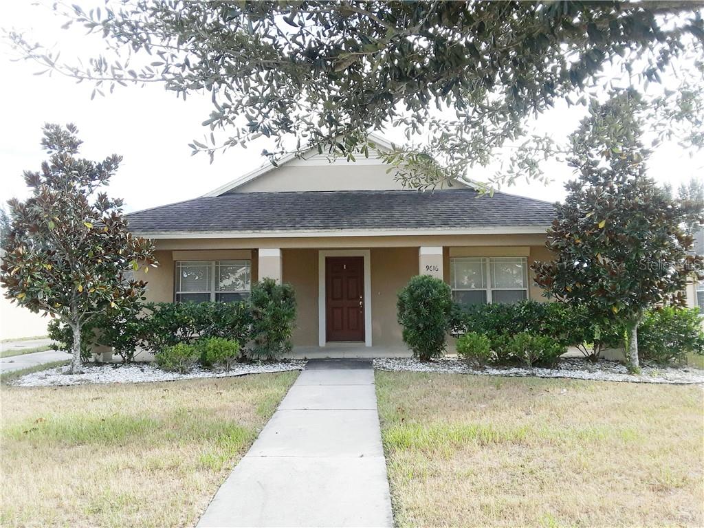9616 Highland Ridge Drive Hudson, FL 34667 - Photo 1 of 1 a front view of a house with a yard and potted plants