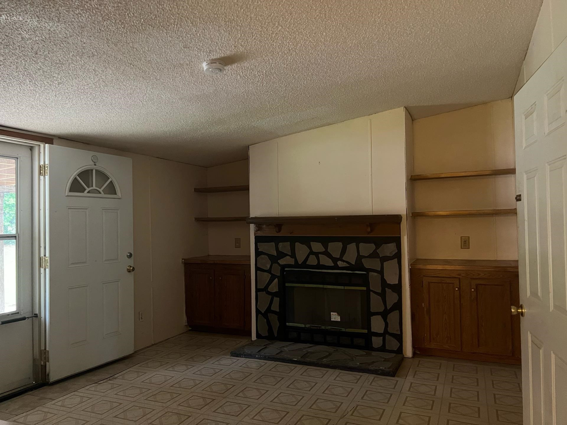 Fireplace and built in book case highlight this room. den