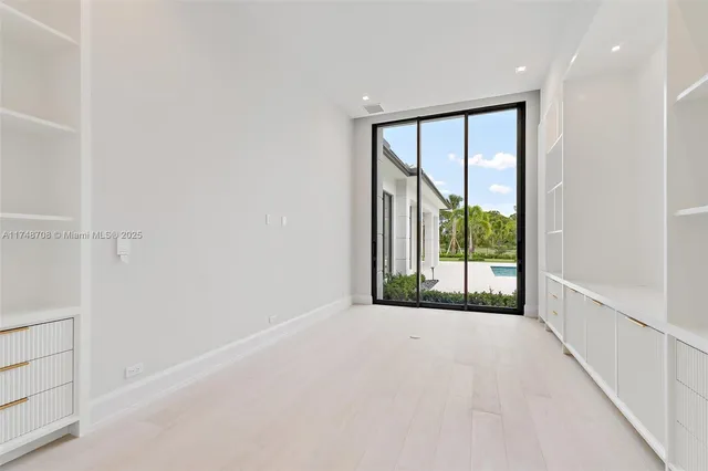 a living room with a fireplace and a large window
