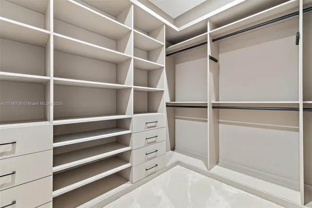 a front view of a house with a yard and palm trees