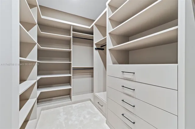 a view of a house with a yard and potted plants