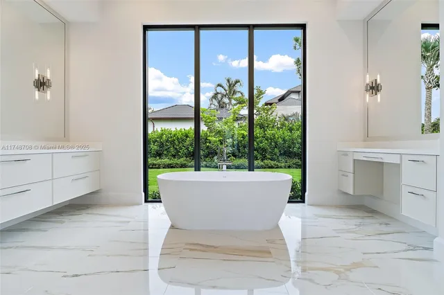 an aerial view of residential houses with outdoor space and pool
