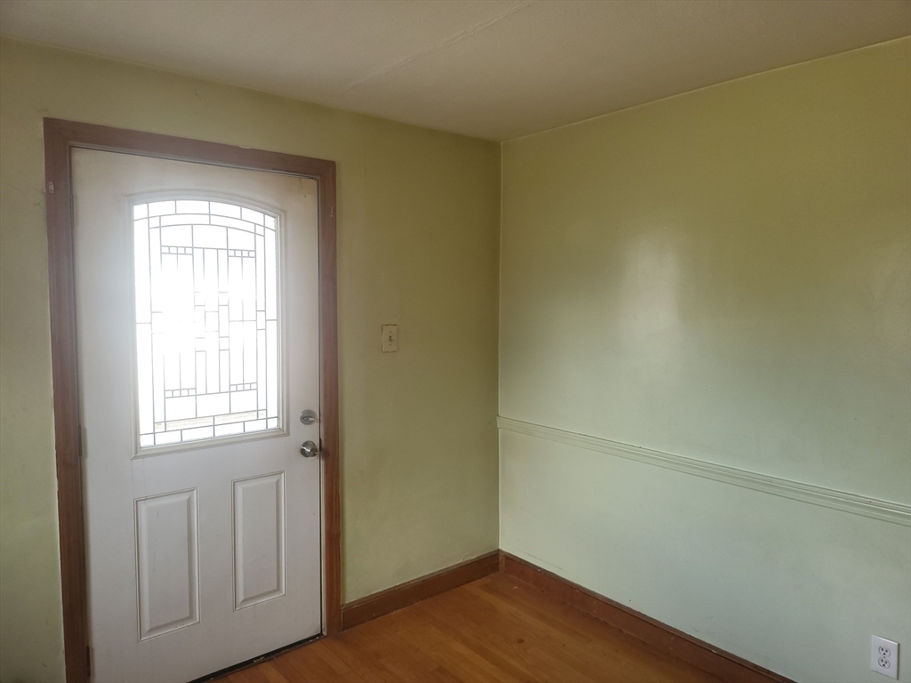665 Parker Street Springfield, MA 01129 - Photo 14 of 25 an empty room with wooden floor and windows