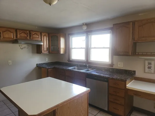 a kitchen with a sink a stove and cabinets