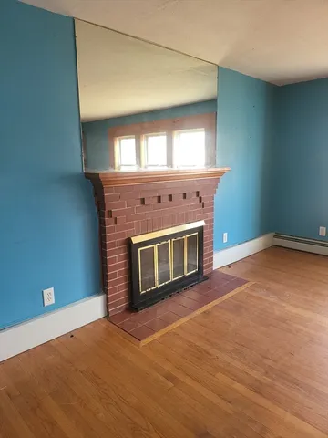 a view of an empty room with a fireplace
