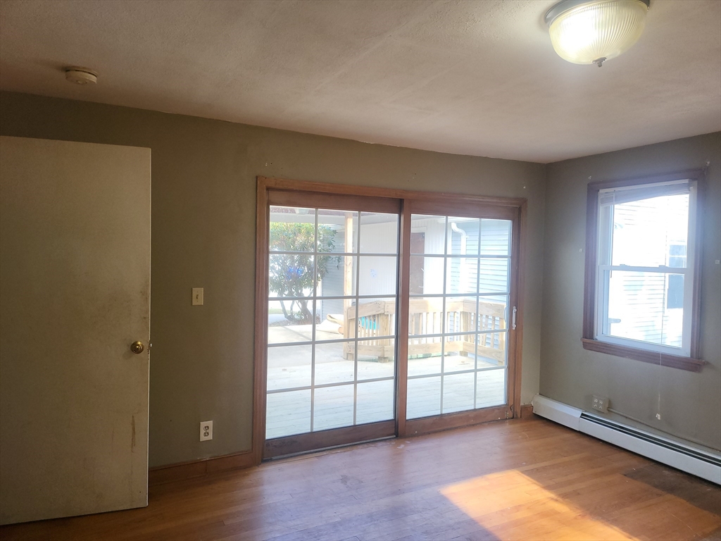 665 Parker Street Springfield, MA 01129 - Photo 9 of 25 an empty room with wooden floor and windows