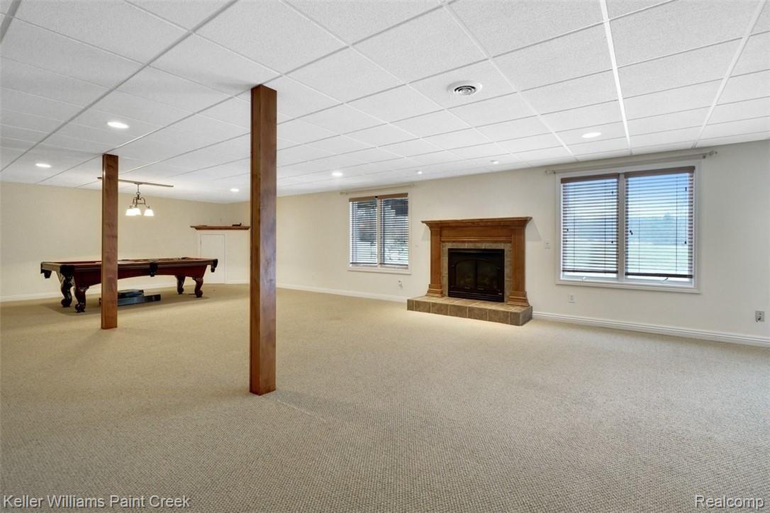 1400 Army Road Leonard, MI 48367 - Photo 38 of 56 Walk out finished lower level with fireplace for those cold winters.