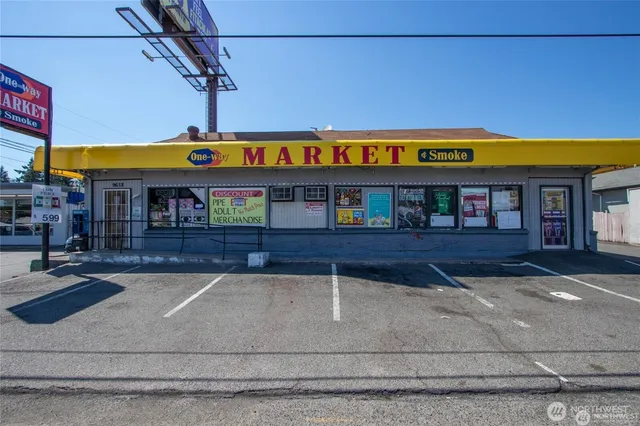 a view of a cafe with a table and chairs under an umbrella