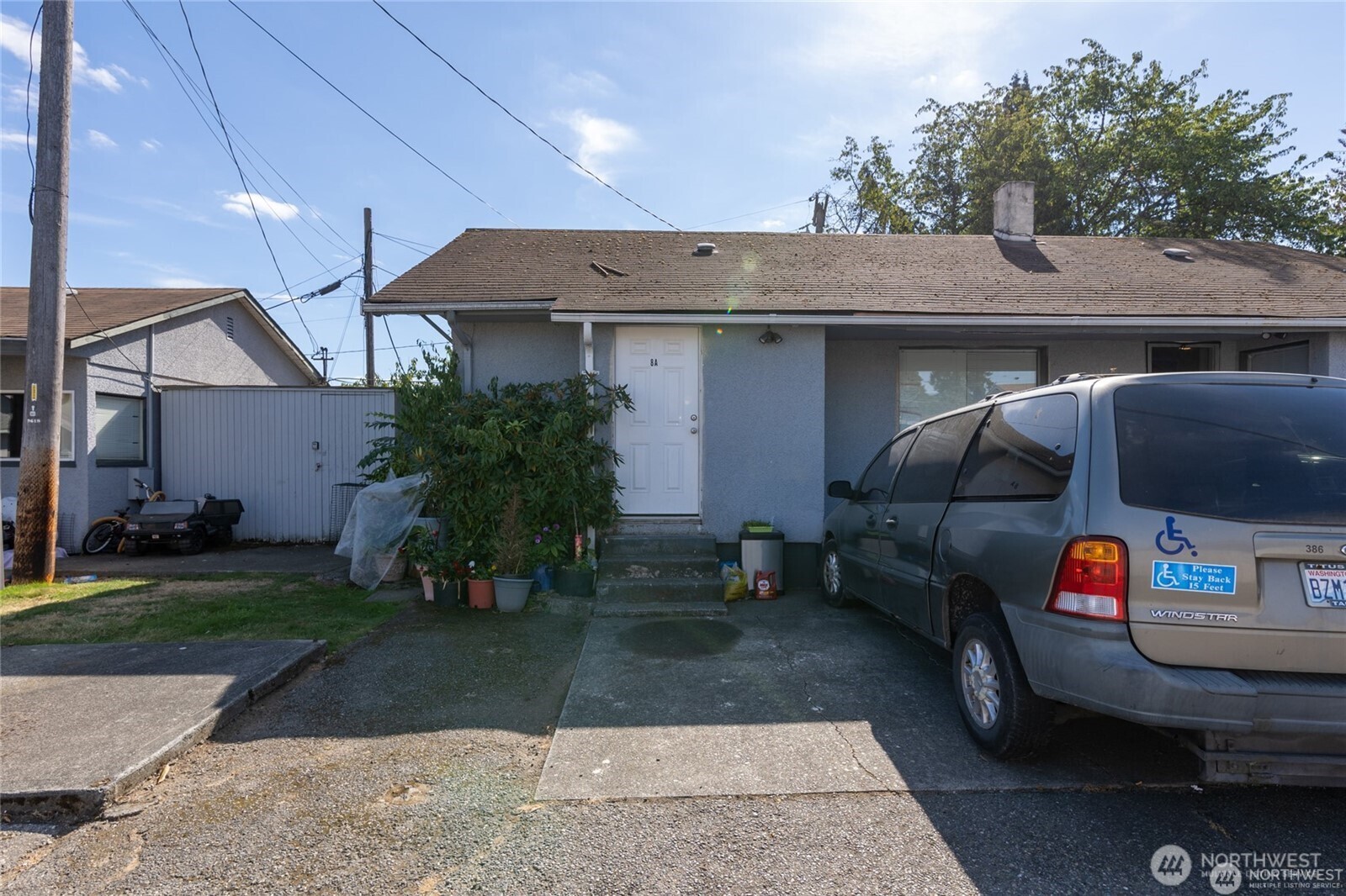 9618 Pacific Avenue Tacoma, WA 98444 - Photo 9 of 14 a front view of a house with garden