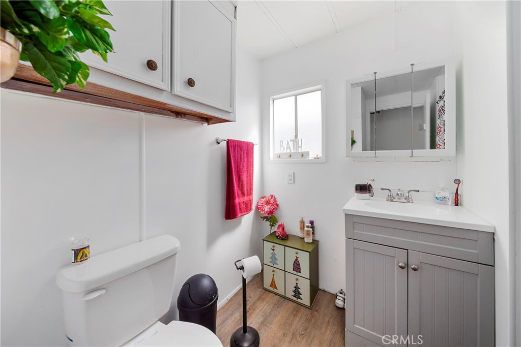 4101 Paramount Boulevard, Unit 27 Pico Rivera, CA 90660 - Photo 13 of 22 a bathroom with a sink mirror vanity and toilet