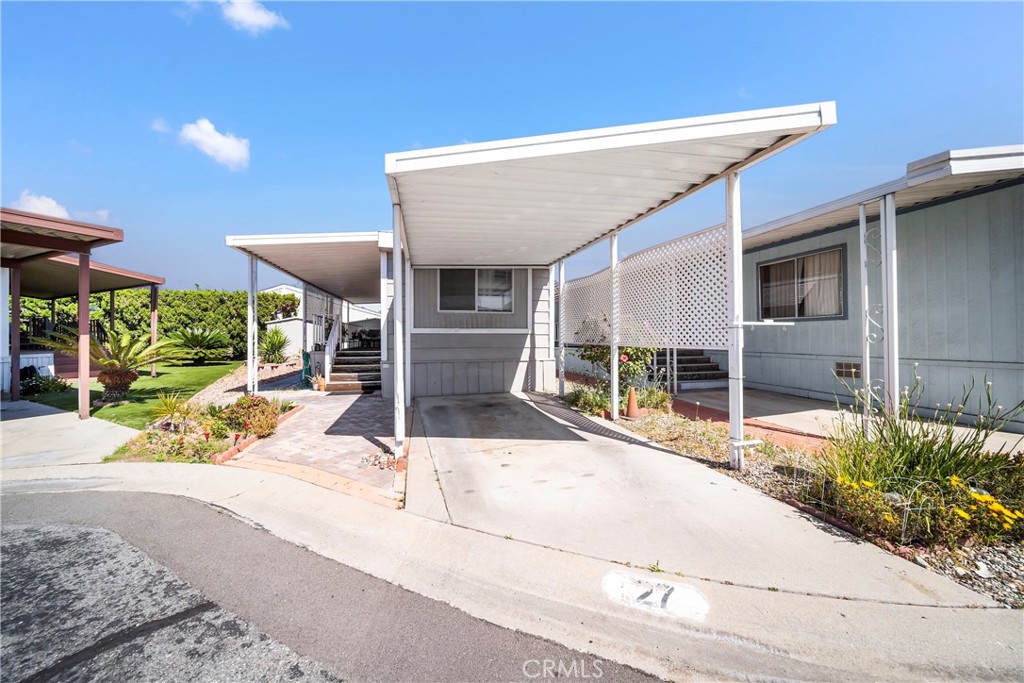 4101 Paramount Boulevard, Unit 27 Pico Rivera, CA 90660 - Photo 3 of 22 a view of a patio with table and chairs under an umbrella