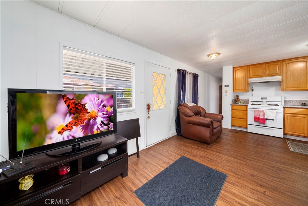 4101 Paramount Boulevard, Unit 27 Pico Rivera, CA 90660 - Photo 9 of 22 a living room with furniture and a flat screen tv